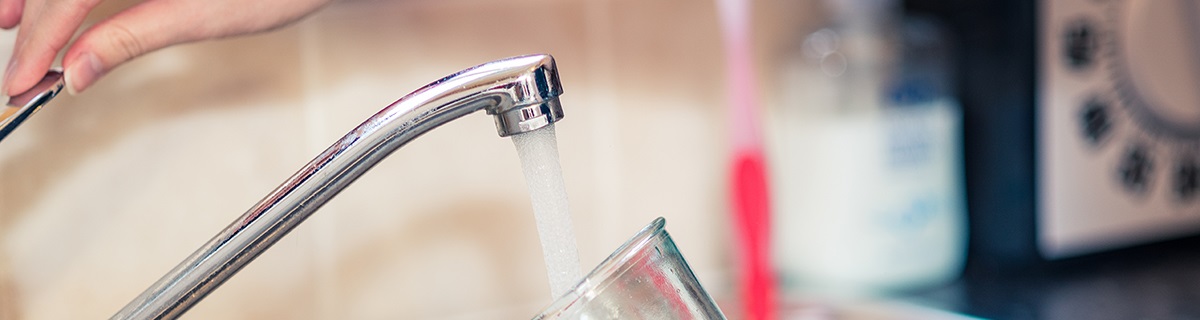 Filling glass with tap water