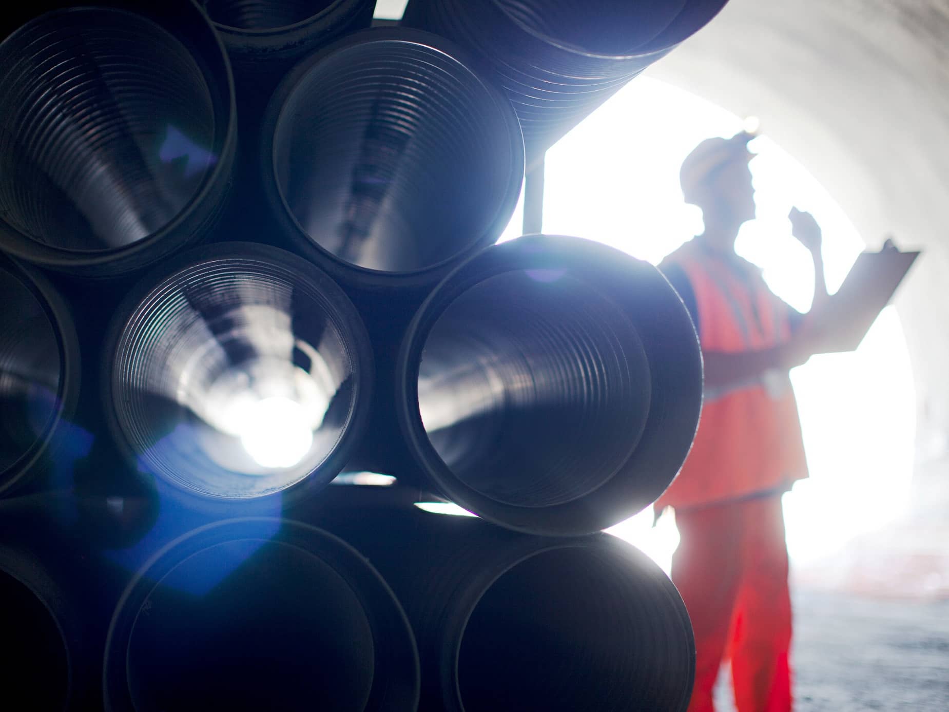 Man standing next to pipes