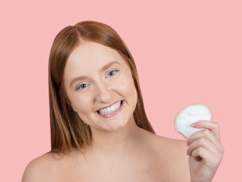 girl holding reusable cotton pad