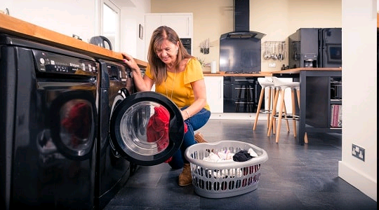Woman filling washing machine