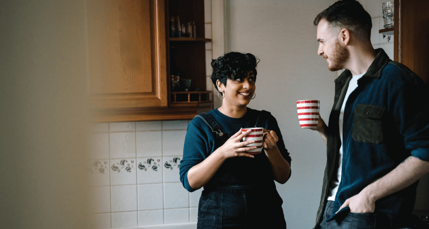 Man and woman drinking cuppas in kitchen