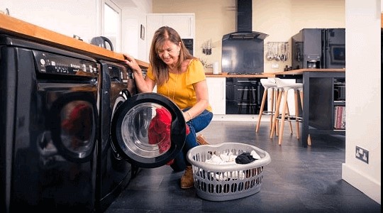 Woman filling washing machine